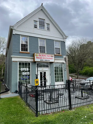 Blue two-story storefront of Dusmesh Indian Restaurant with patio seating at 944 Ludlow Ave in Cincinnati