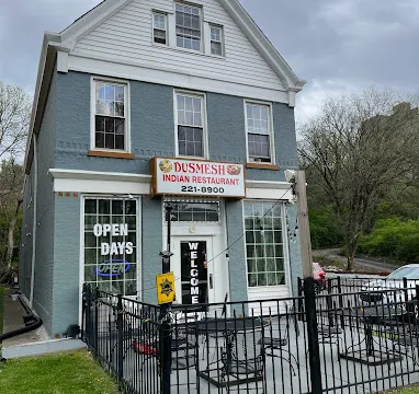 Blue two-story storefront of Dusmesh Indian Restaurant with patio seating at 944 Ludlow Ave in Cincinnati