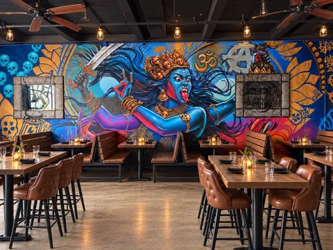 Dining room at Aatma Curry House inside Widowmaker Brewing in Brighton, Boston, with a large blue Kali mural behind wooden tables and leather bar stools