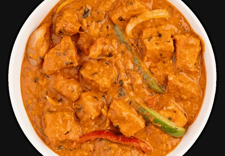 Chicken tikka masala with green chile in a white bowl, from Tikka Drive in Chandler