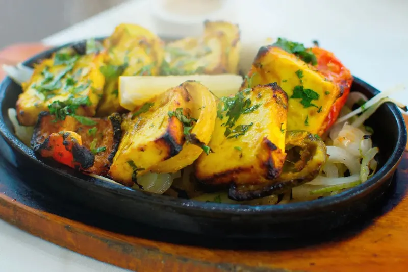 Sizzling spiced paneer with peppers and onions